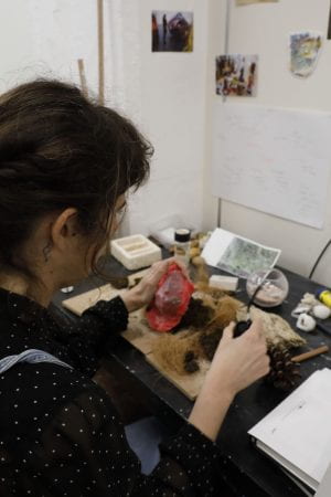 an artist working with organic materials in her studio