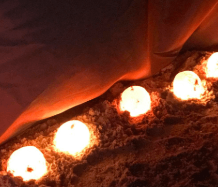 lit up spheres on sand