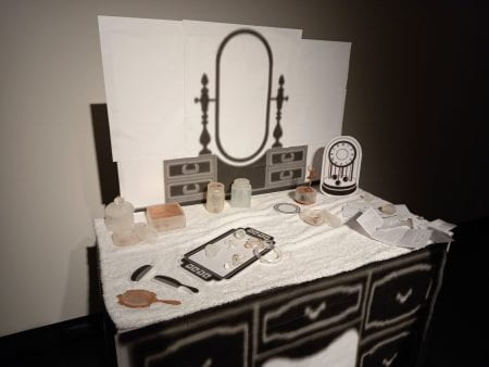 black and white paper objects, soap and copper items on a towel