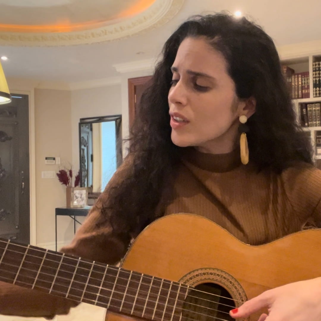 Video still of Eshet Chayil song performance on guitar in New York