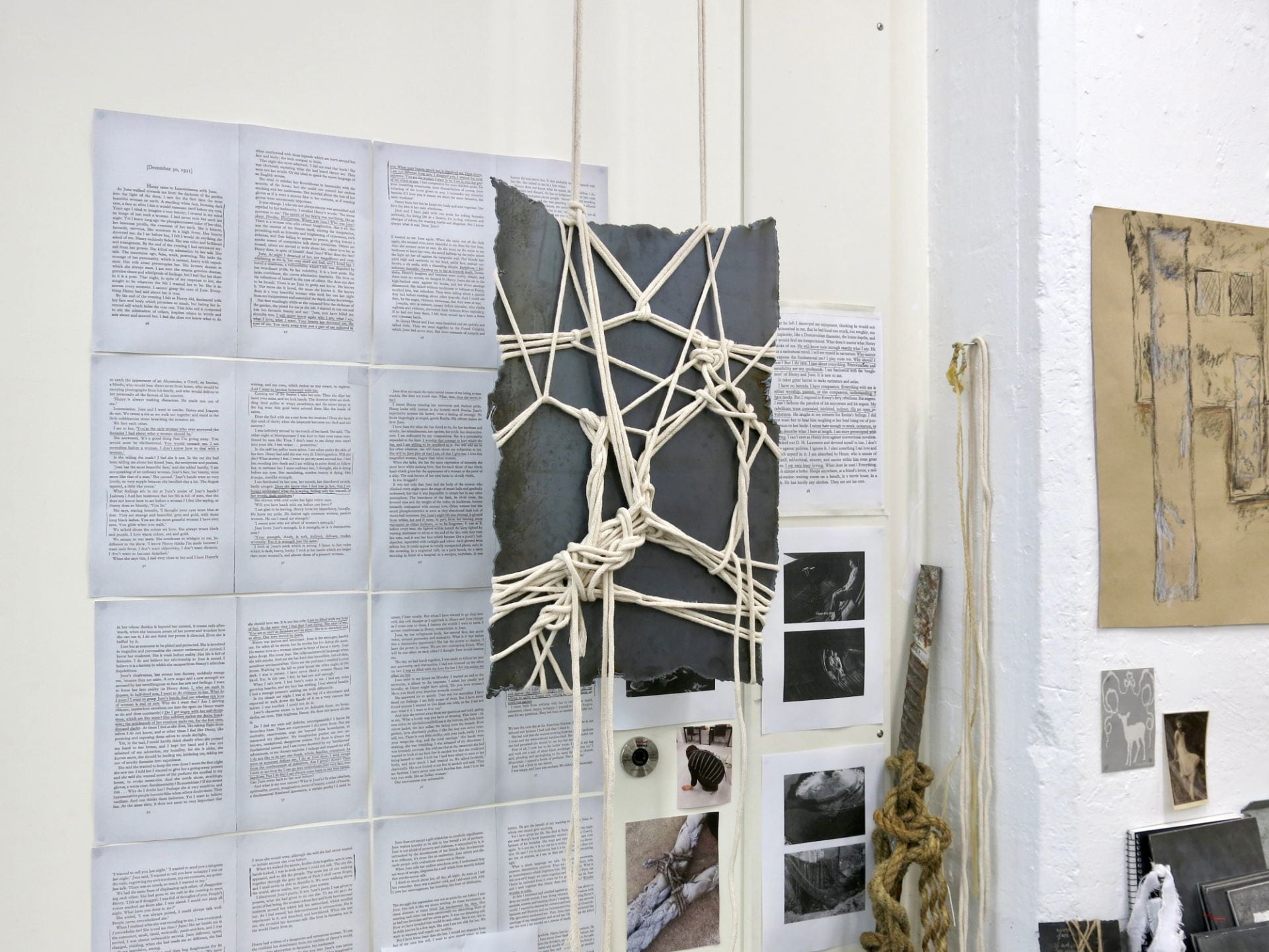 Photograph of Yvonne's studio space with rope-bound steel sculpture and annotated readings on the walls