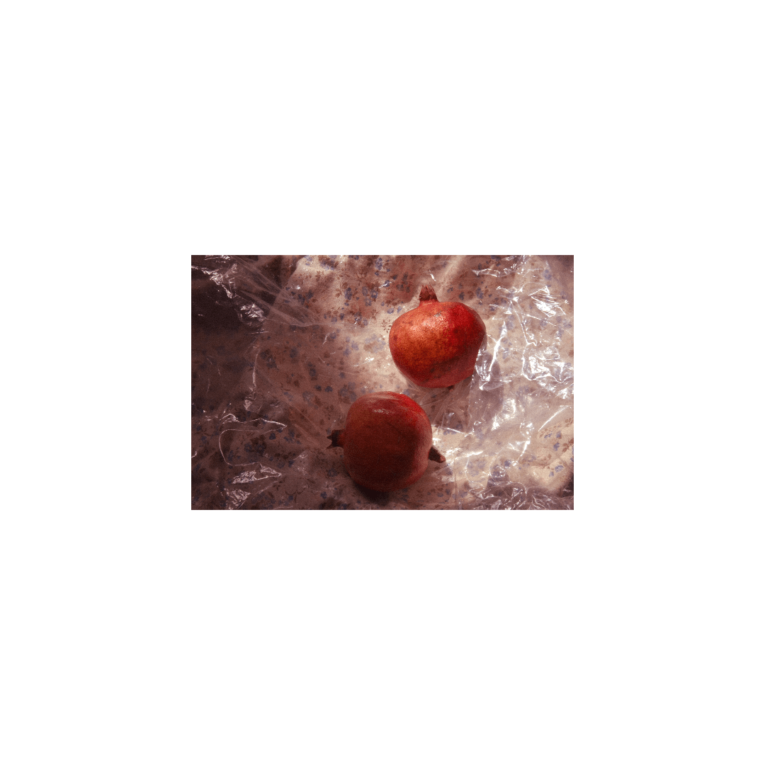 photographs of pomegranates wrapped in plastic and fabric