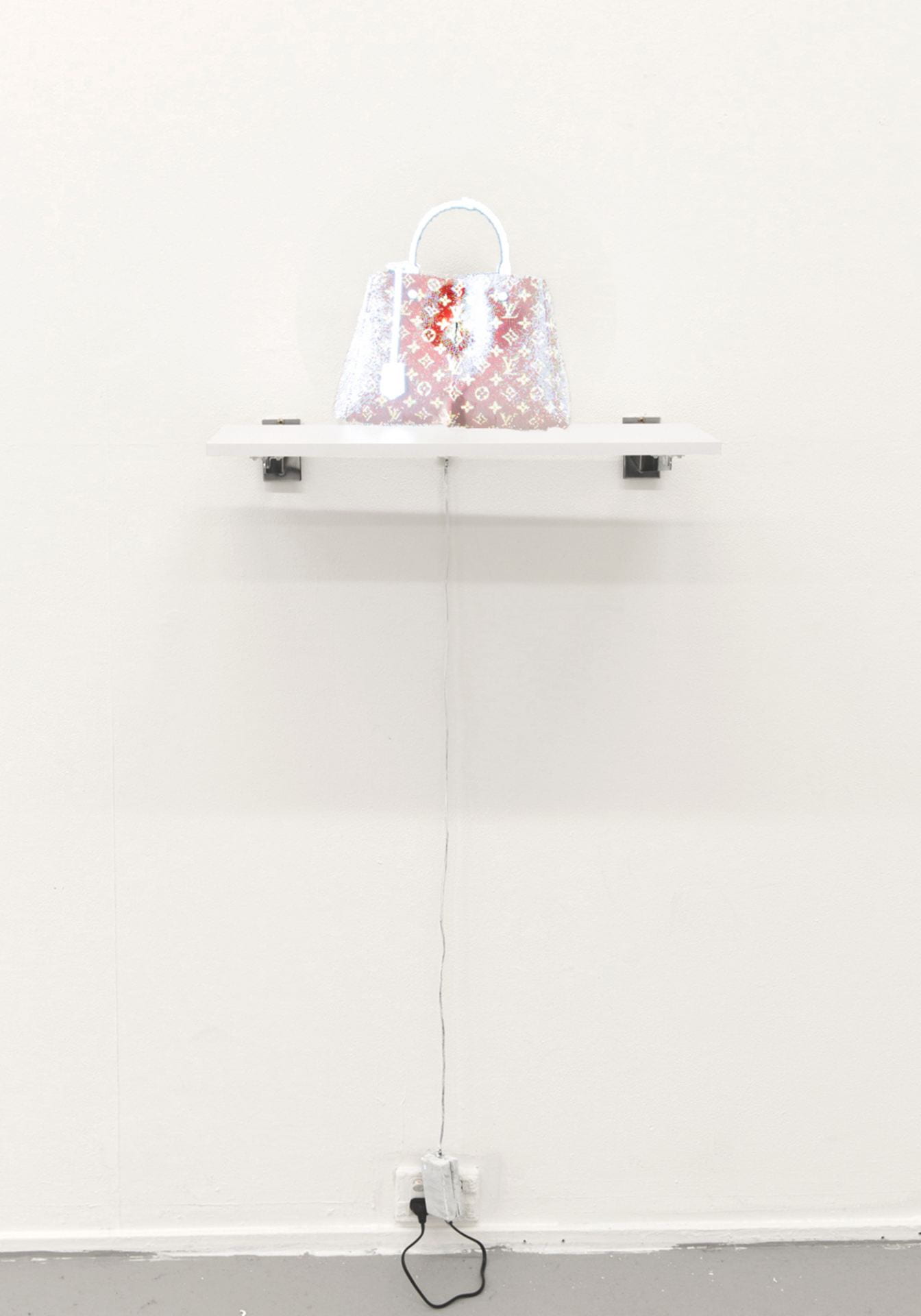 A hologram display of a louis vuitton Montaigne MM bag appears above a white shelf