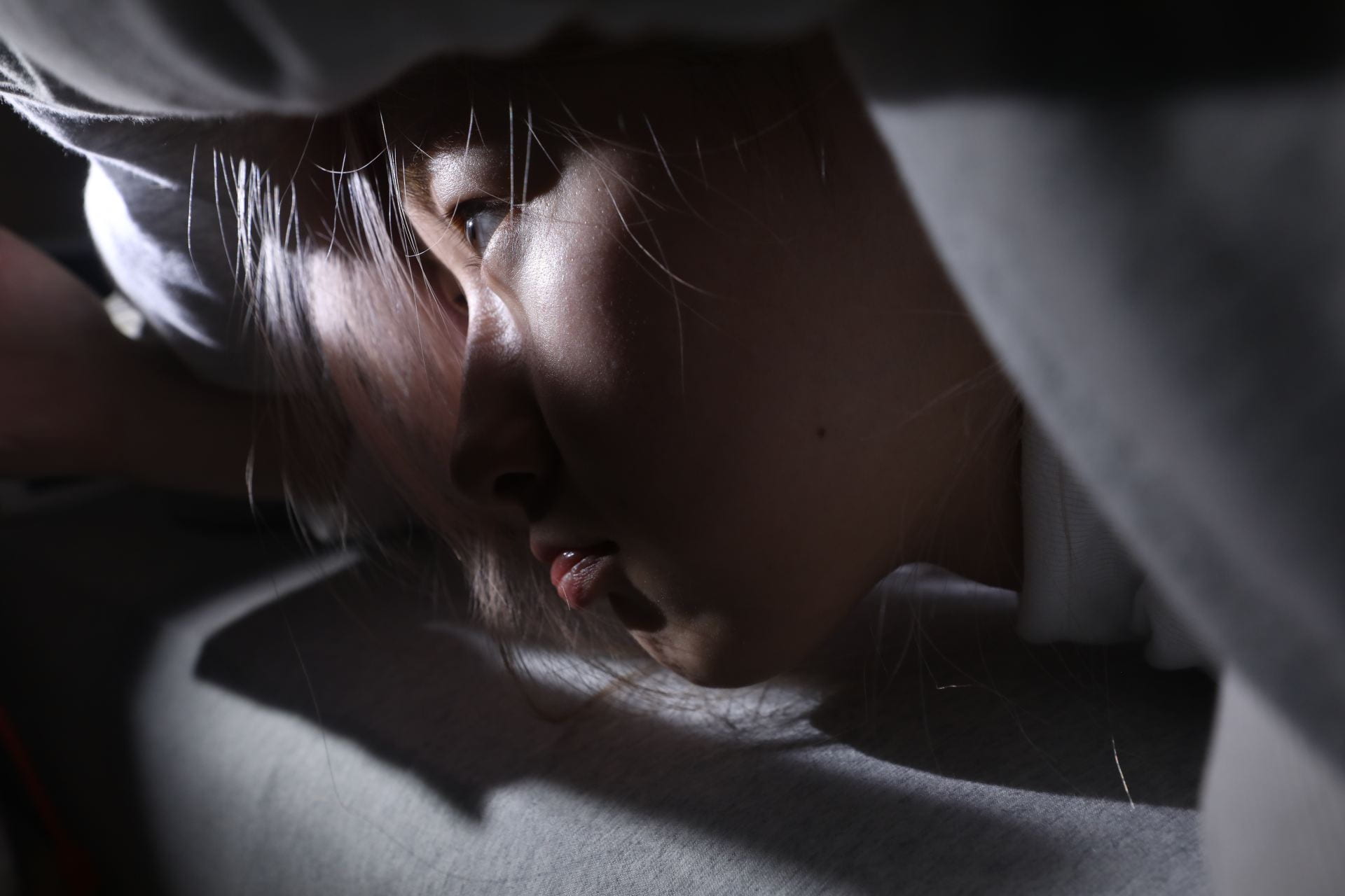 photograph of self-protray about hide under the covers
