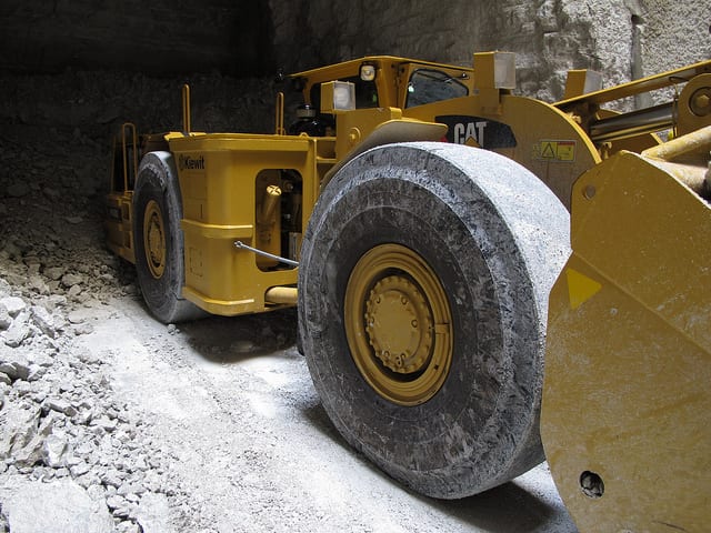 Caterpillar earth mover digging underground in a mine